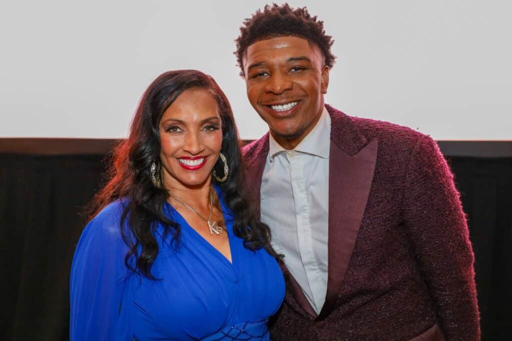 652858537_1358080509686607_7750649189653552149_n-1024x683 | Akron Urban League a Smiling Woman in a Royal Blue Dress Posing with a Smiling Man in a Burgundy Glitter Suit at an Event.