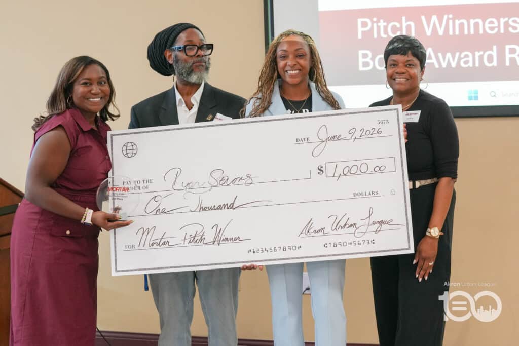 Dsc00549-1024x683 | Akron Urban League Four Adults on a Stage Pose with a Large Ceremonial Check for ,000 Dated June 9, 2026 During an Award Ceremony.