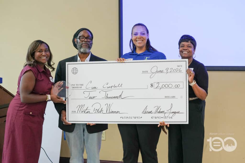 Dsc00551-1024x683 | Akron Urban League Four People Pose with a Large Ceremonial Check for ,000, Dated June 9, 2026, in a Room with a Projection Screen Behind Them.