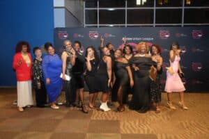 Dsc05363-300x200 | Akron Urban League Group of About 15 People in Formal and Semi-formal Attire Posing Together for a Photo at a Formal Event, Standing on a Carpet with a Dark Branded Backdrop Behind Them.