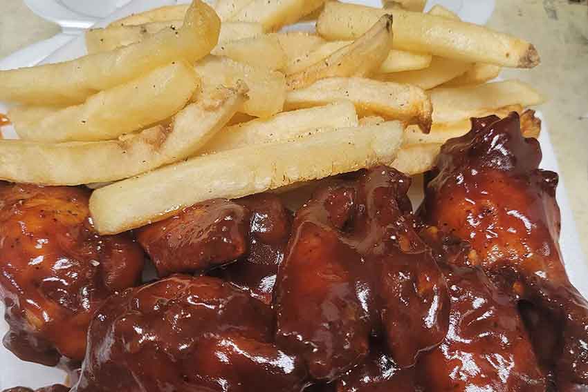 Plate of french fries and chicken wings