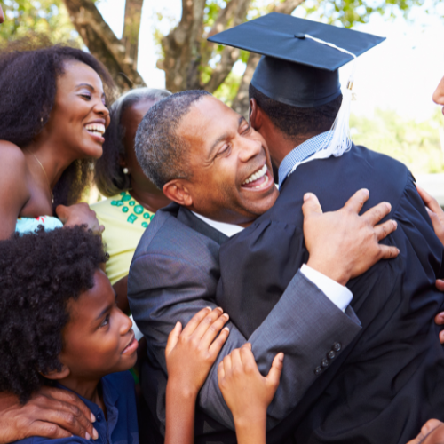 Family hugging a graduate