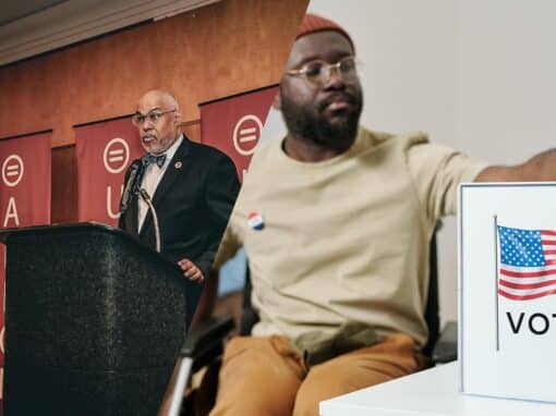 Vote Hero Speaker at a podium delivering a speech at a political event, with a person in a wheelchair beside a voting display featuring the American flag.