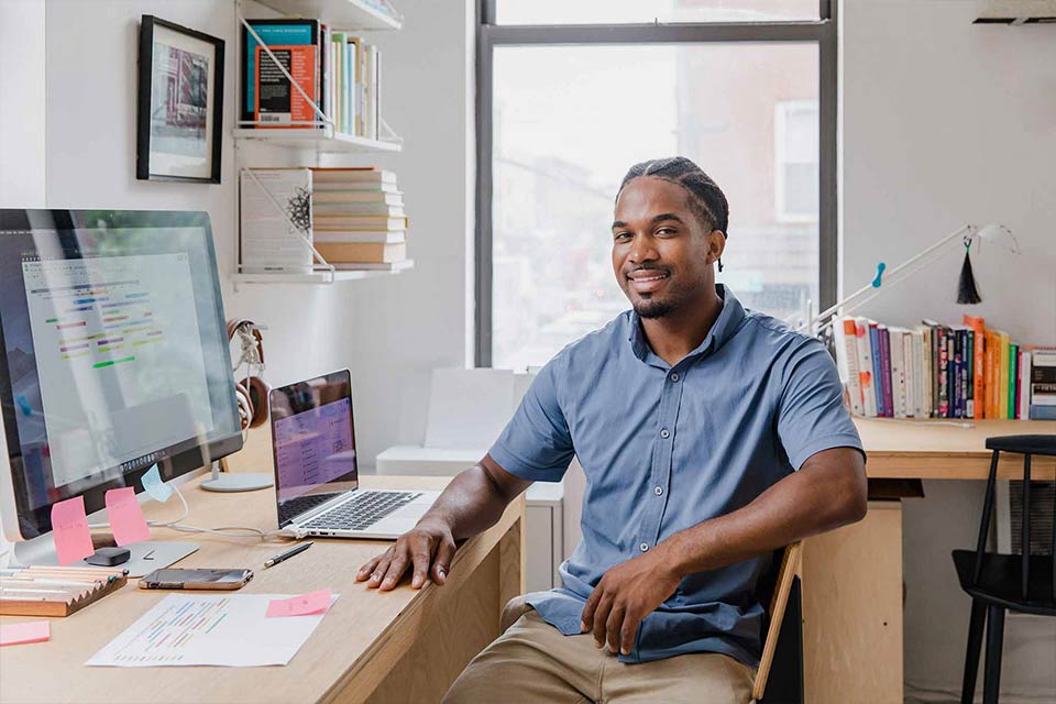 Young Black man sitting at his desk
