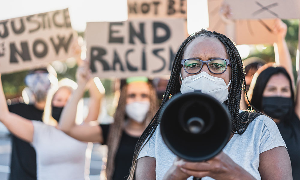 Group of demonstrators on road from different cultures protest for equal rights - Focus on Black senior woman