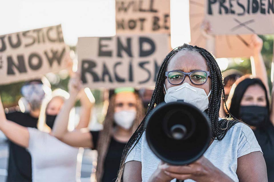 Group of demonstrators on road from different cultures protest for equal rights - Focus on Black senior woman