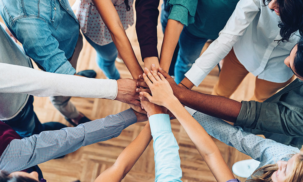 Diverse group of hands overlapping one another