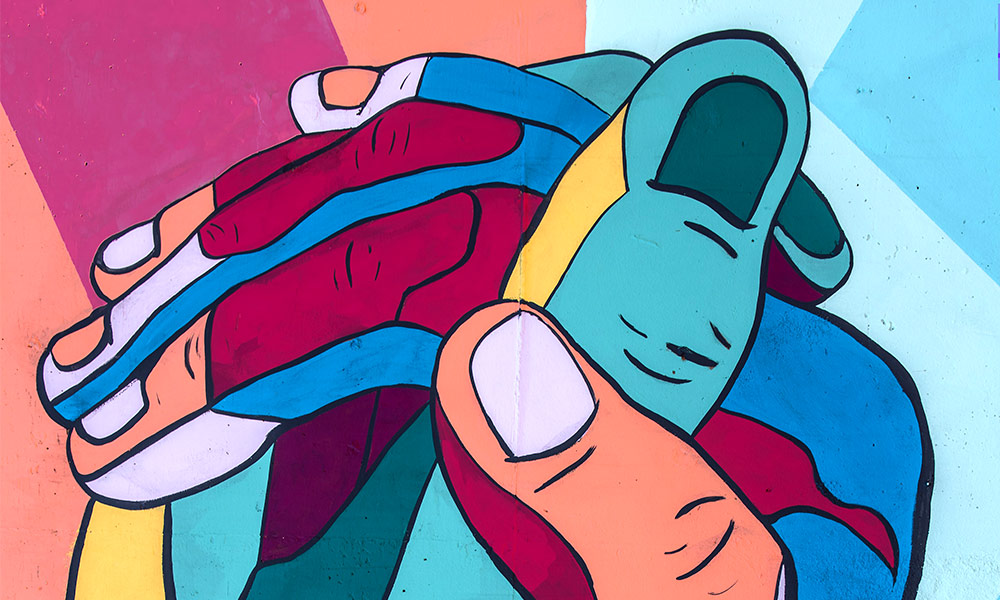 Mural of two colorful hands embracing