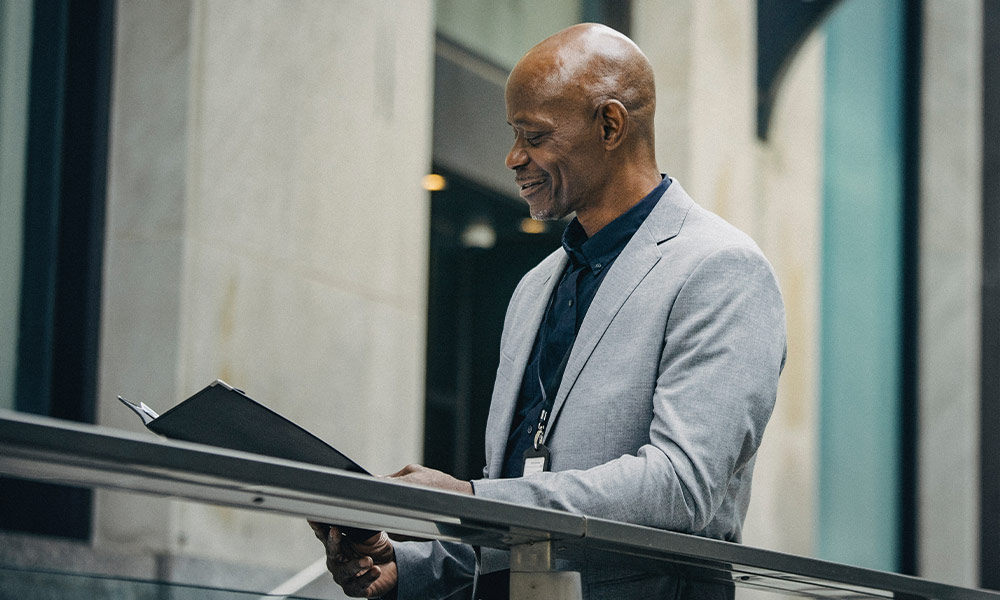 Older Black man in a suit reviewing information