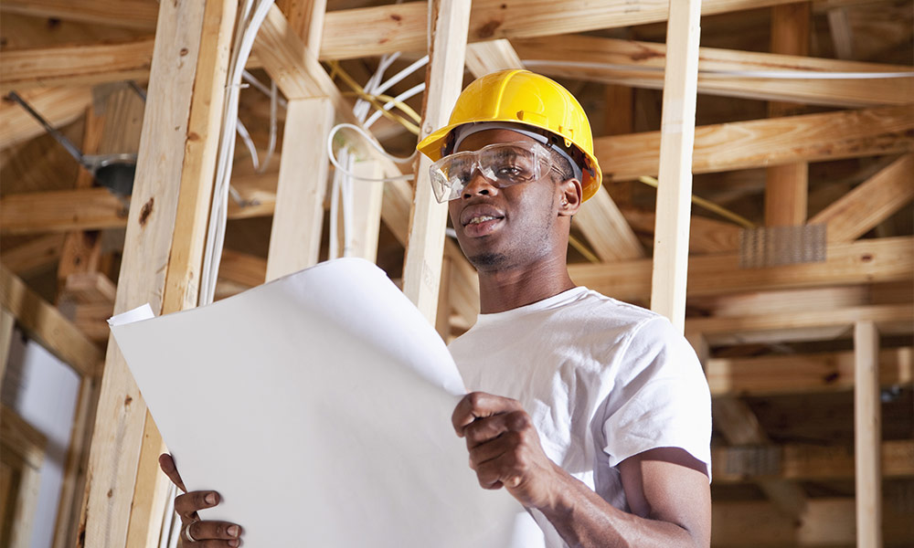 Construction worker holding plans