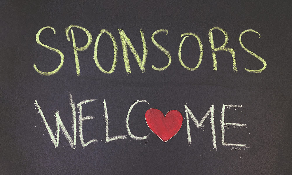 Sponsors welcome concept on blackboard with small wooden red heart
