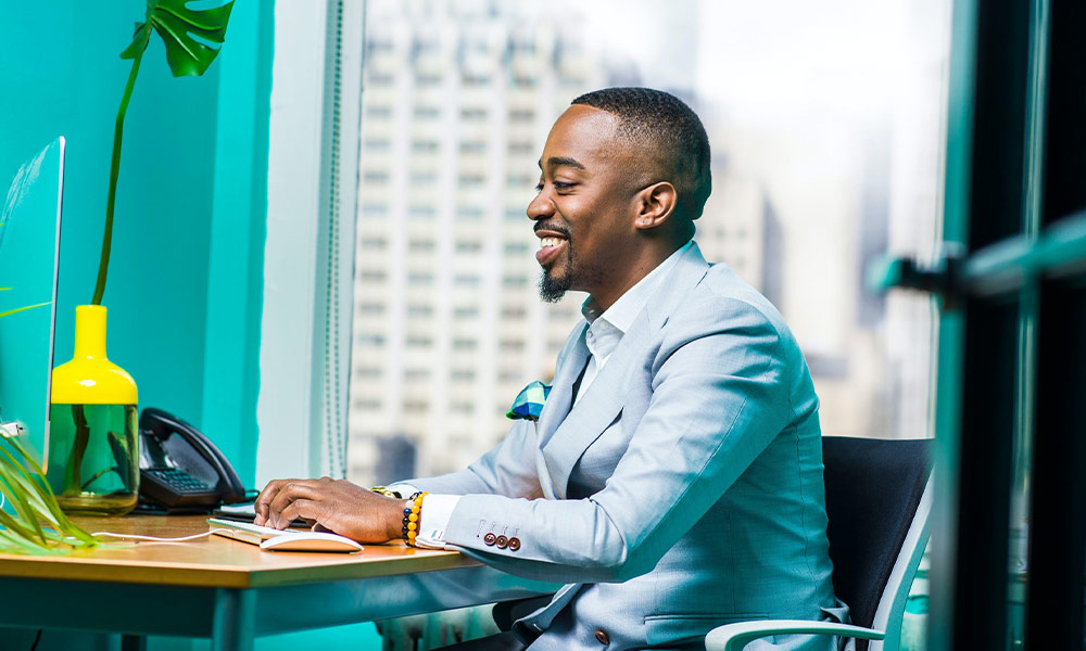 Professional Black man at a desktop computer