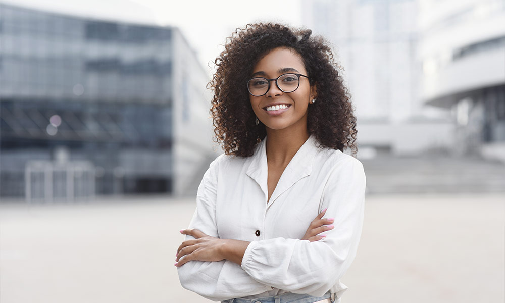 Young business woman with crossed arms outdoor portrait